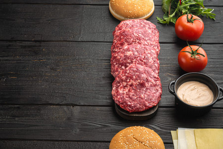 Burger banner. Raw ingredients for burger set, on black wooden table background, with copy space for textの写真素材