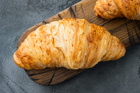 Fresh homemade baked golden brown croissant set, on gray stone background