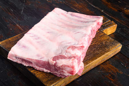 Raw Pork ribs set, on wooden cutting board, on old dark wooden table backgroundの写真素材