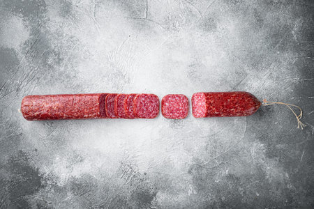 Salami, salami smoked sausage, sliced set, on gray stone table background, top view flat lay, with copy space for textの写真素材