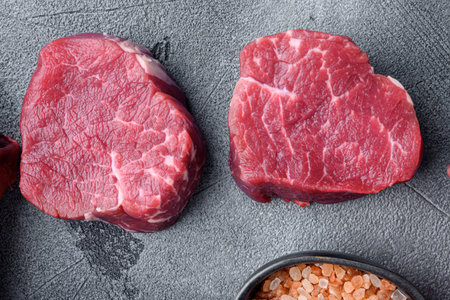 Prime Raw Fillet Mignon tenderloin steaks set, on gray stone background, top view flat lay