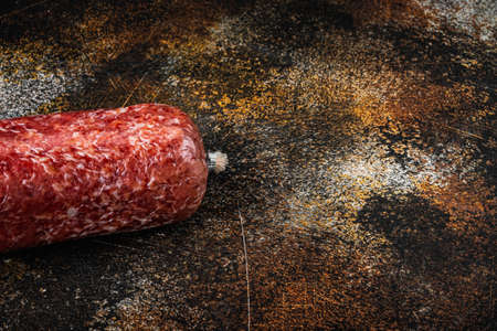 Delicious salami sausage set, on old dark rustic background, with copy space for textの写真素材