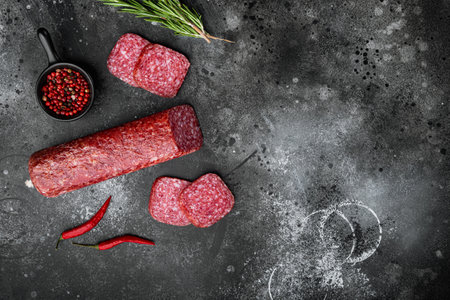 Salami with ingredients set, on black dark stone table background, top view flat layの写真素材