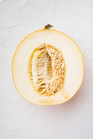 Slice of fresh melon set, on white stone table background, top view flat layの写真素材
