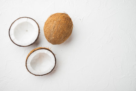 Coconut cuts broken set, on white stone table background, top view flat lay, with copy space for...