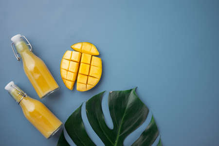 Mango smoothie set, on blue textured summer background, top view flat lay, with copy space for textの写真素材