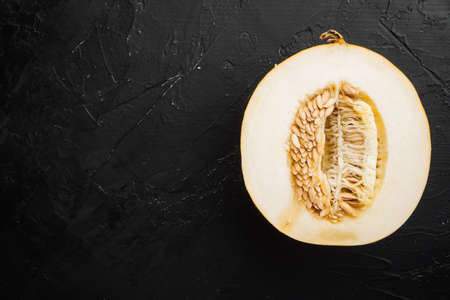Pieces of tasty ripe melon set, on black dark stone table background, top view flat lay, with copy space for textの写真素材
