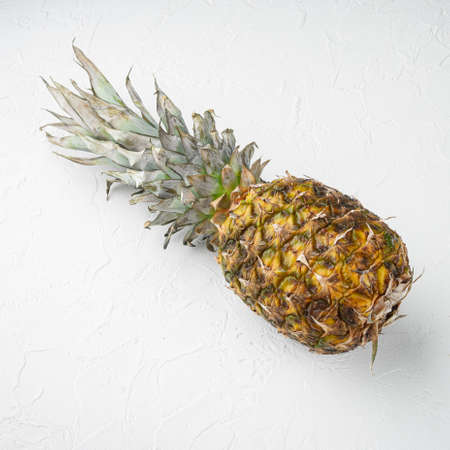 Pineapple whole set, on white stone table background, top view flat lay, square formatの写真素材