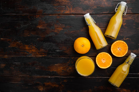 Fresh orange juice set, on old dark wooden table background, top view flat lay, with copy space for...