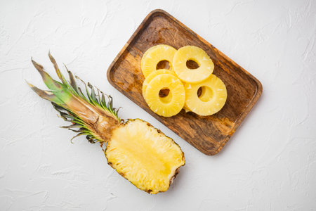 Pineapple cut set, on white stone table background, top view flat lay