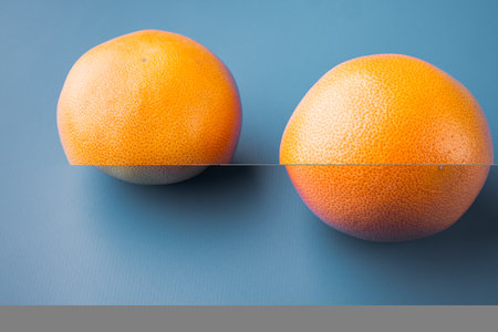 Whole Grapefruit set, on blue textured summer backgroundの写真素材