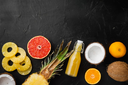 Tropical fruit set, on black dark stone table background, top view flat lay, with copy space for...