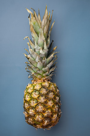 Hawaiian pineapple set, on blue textured summer background, top view flat lay
