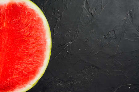 Slice of watermelon set, on black dark stone table background, top view flat lay, with copy space for textの写真素材