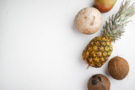 Exotic fruits, pineapple and Coconut set, on white stone table background, top view flat lay, with...