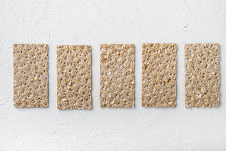 Low calories snack bread set, on white stone table background, top view flat lay, with copy space...