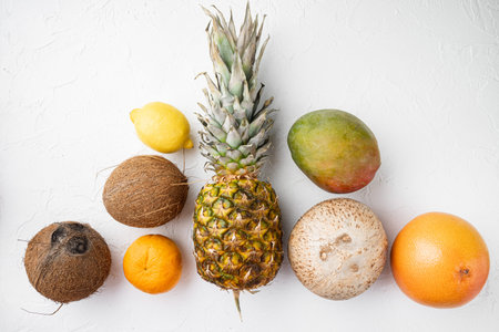 Fresh fruits tropical composition set, on white stone table background, top view flat lay