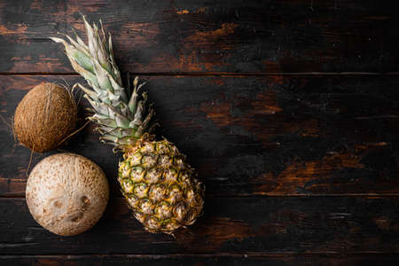 Exotic fruits, pineapple and Coconut set, on old dark wooden table background, top view flat lay, with copy space for textの写真素材