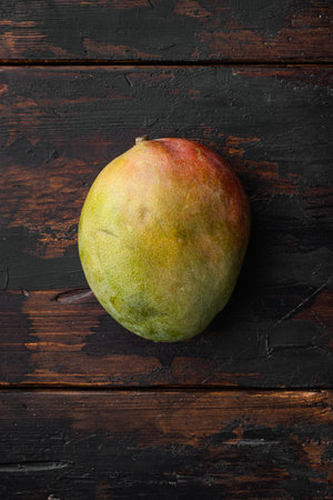 Ripe mango fruit set, on old dark wooden table background, top view flat lay