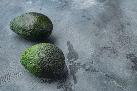 Ripe pair of green avocado set, on gray background with copy space for textの写真素材
