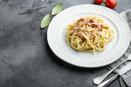 Carbonara pasta. Spaghetti with pancetta, egg, parmesan cheese set, on gray stone background, with copy space for textの写真素材