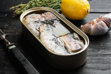 Sardine cans of preserves set, on black wooden table background