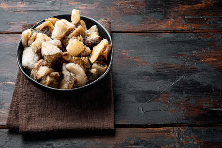 Frozen wild mushrooms set, in bowl, on old dark wooden table background, with copy space for textの写真素材