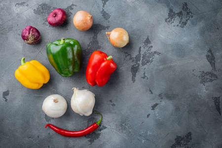 Collection of vegetables Bell pepper and onion, on gray background, top view flat lay with copy space for textの写真素材