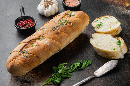 Garlic bread filled compound herb butter set, on old dark rustic table background
