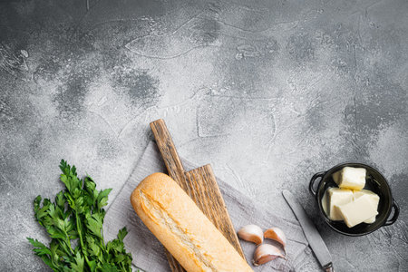 Garlic bread compound butter and herb ingredients set, on gray stone table background, top view flat...