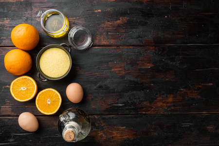 Homemade orange cake ingredients, with eggs and honey set, on old dark wooden table background, top view flat lay, with copy space for textの写真素材