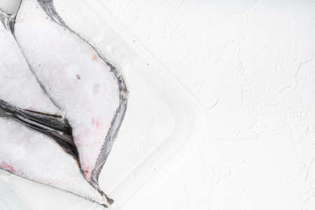 Halibut iced fillet plastic pack set, on white stone table background, top view flat lay, with copy space for textの写真素材