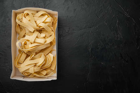 Fresh Homemade Pasta set, on black dark stone table background, top view flat lay, with copy space for textの写真素材