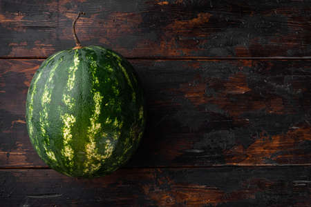 Organic watermelon set, on old dark wooden table background, with copy space for textの写真素材