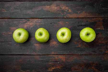 Green apple set, on old dark rustic table background, top view flat lay, with copy space for textの写真素材