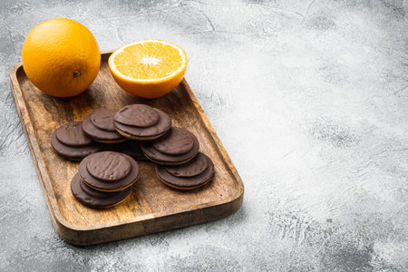 Biscuit filled with orange, topped with chocolate set, on gray background, with copy space for text