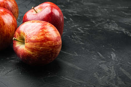 Fresh red apple set, on black dark stone table background, with copy space for textの写真素材
