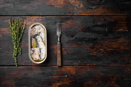 Can of sardines in olive oil set, on old dark wooden table background, top view flat lay, with copy space for textの写真素材