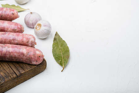 A natural raw sausage set, on white stone table background, with copy space for textの写真素材