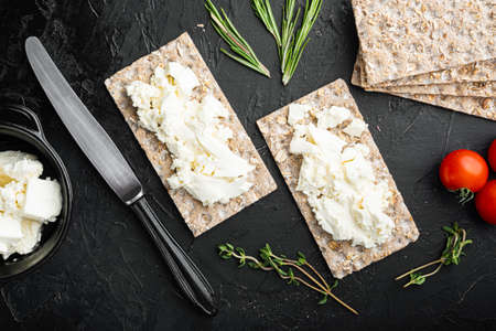 Crispbread sandwich set, on black dark stone table background, top view flat layの写真素材