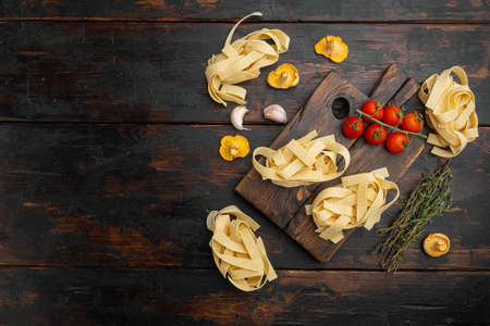 Pasta ingredients set, on old dark wooden table background, top view flat lay, with copy space for textの写真素材