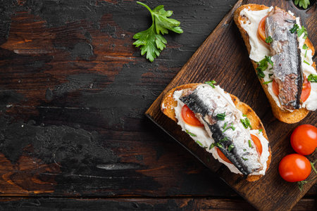 Homemade sardine sandwiches with Ricotta set, on old dark wooden table background, top view flat lay, with copy space for textの写真素材