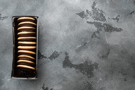 Beautiful delicious bitten cake from biscuit dough with marmalade set, in plastic tray container, on gray background, top view flat lay, with copy space for textの写真素材