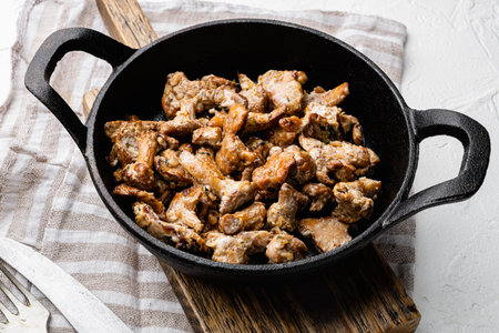 Mushroom chanterelles set, in cast iron frying pan, on white stone table backgroundの写真素材