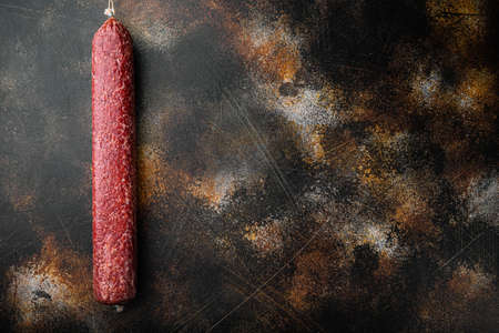 Salami sausage set, on old dark rustic background, top view flat lay, with copy space for textの写真素材