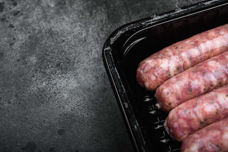 Flesh meat product for cooking packed in box set, on black dark stone table background, with copy space for textの写真素材