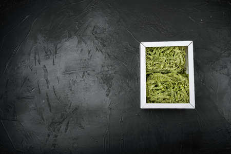 Italian pasta in package, on black dark stone table background, top view flat lay, with copy space for textの写真素材