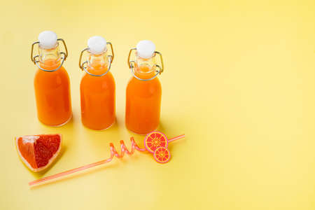 Grapefruit juice set, on yellow textured summer background, with copy space for textの写真素材