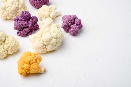 Fresh organic cauliflower cut into small pieces set, on white stone table background, with copy space for textの写真素材