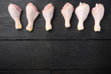 Uncooked Chicken Thigh or legs, drumsticks set, on black wooden table, top view flat lay, with copy space for textの写真素材